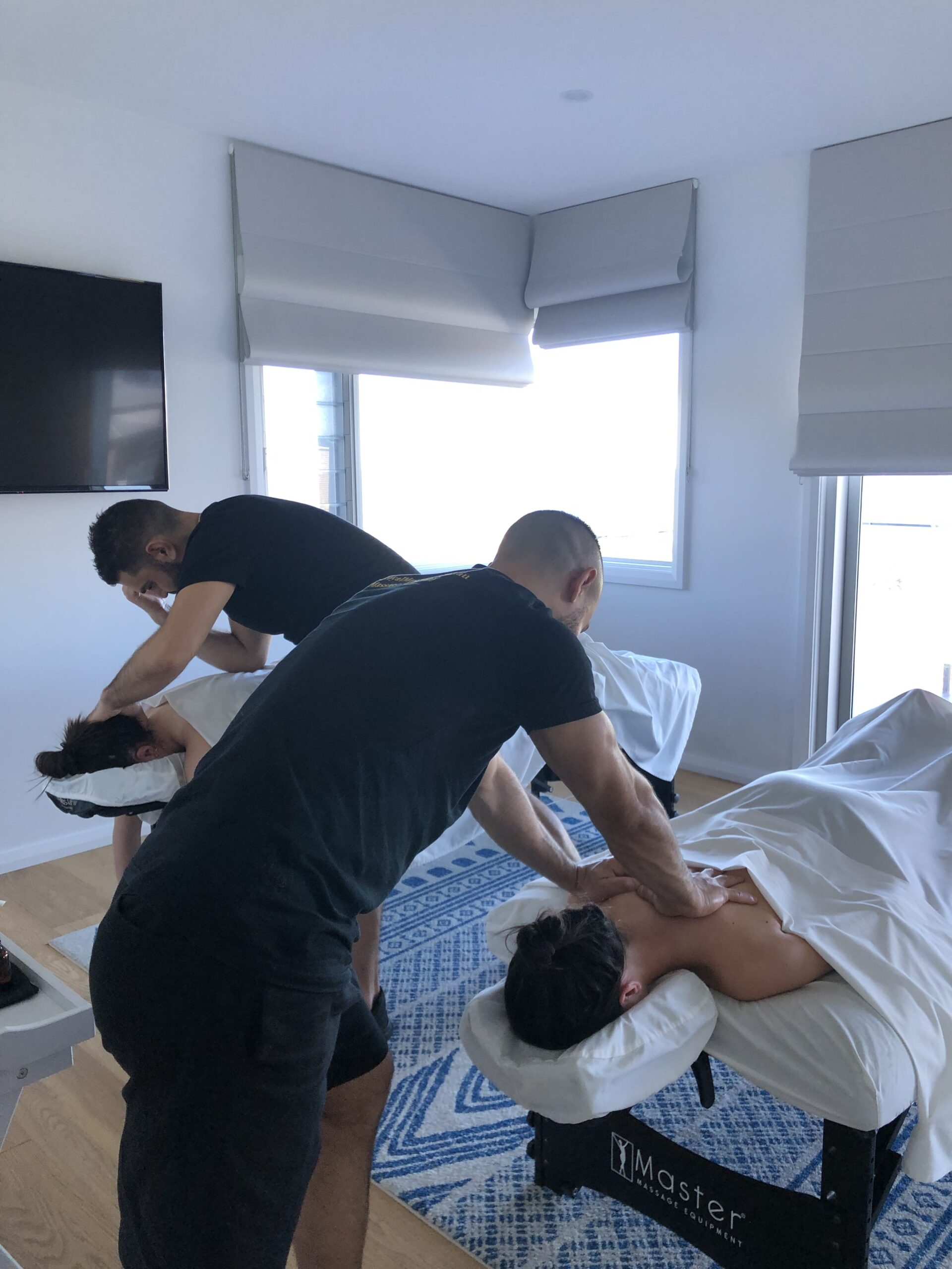 massuers doing table massage