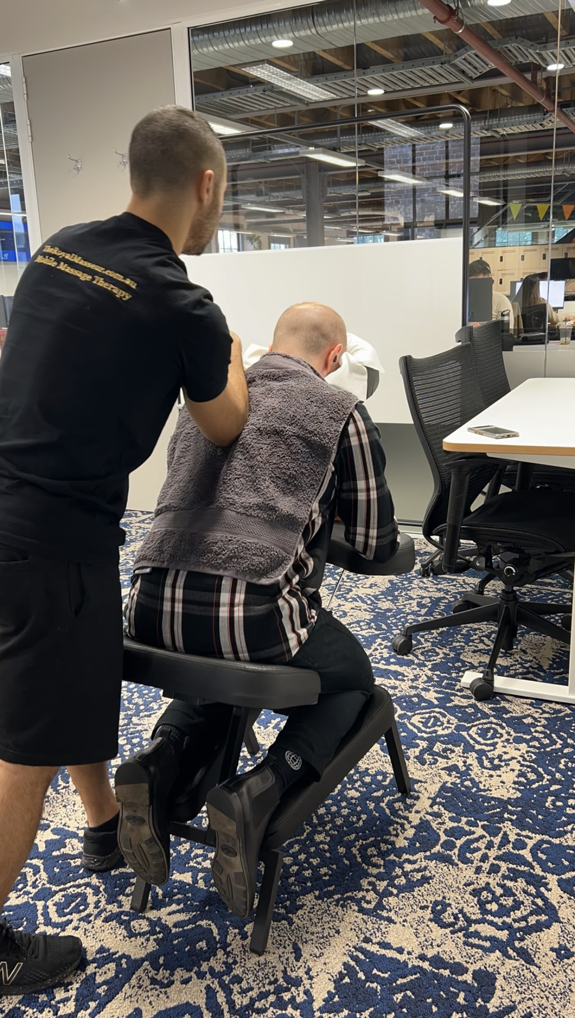 lady being given a massage in a chair in the office