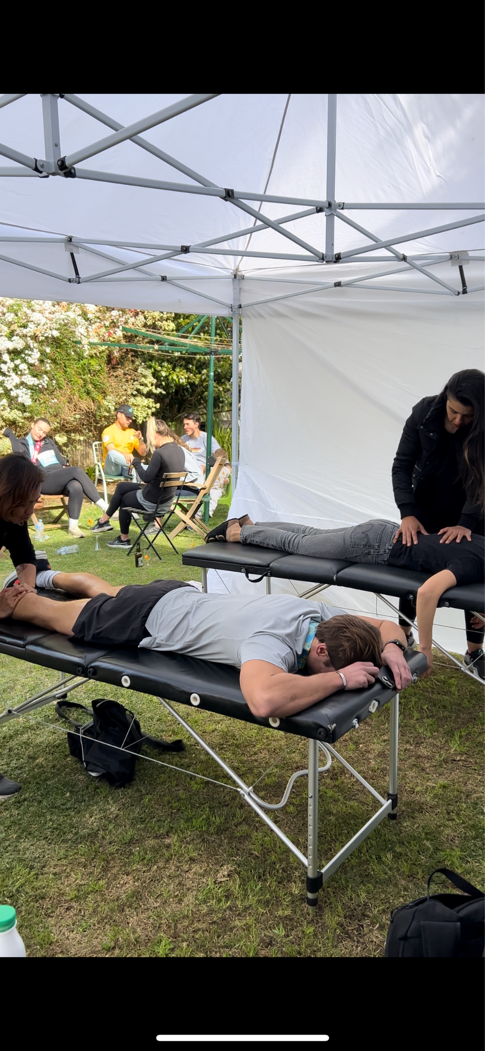 a person being massaged whilst outside in a massage tent